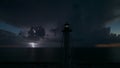 White tall lighthouse on sea shore with blinking light at stormy night for commercial vessels navigation. Thunderstorm