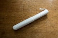 White tampon with cardboard applicator on wood