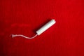 White tampon on red blanket - minimalistic - pms