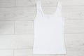White tank top back view tshirt template mock up on white wooden background top view Royalty Free Stock Photo
