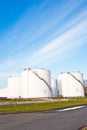 White tanks for petrol and oil in tank farm with blue sky Royalty Free Stock Photo