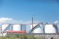 white tanks in tank farm with blue sky. Royalty Free Stock Photo