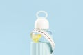 White tape measure around lemon water bottle and red apple Royalty Free Stock Photo