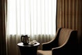 White tea cup coffee cup on the table by a sofa couch in hotel room, kettle Royalty Free Stock Photo