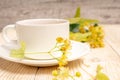 tea cup with linden flowers on wooden table Royalty Free Stock Photo