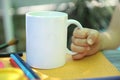 White tea mug empty space mockup, child hand with empty white cup