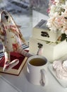 White tea mug, hydrangea flowers, marshmallow , book, box, toy hare on the windowsill Royalty Free Stock Photo
