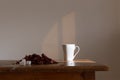 White teacup on the old wooden table and bunch of dried and red hibiscus karkade flowers on it with sugar