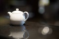 White teapot for brewing tea on a black stock photo