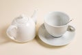 White teapot and an empty cup of tea spoon. Royalty Free Stock Photo
