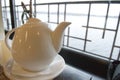 White teapot on a table in restaurant