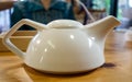 White teapot on the table in restaurant Royalty Free Stock Photo