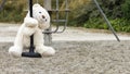 White teddy bear, doing the zip line, in the middle of nature Royalty Free Stock Photo