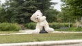 White teddy bear, doing the zip line, in the middle of nature Royalty Free Stock Photo