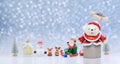 White teddy bear emerges from open gift box with row of Santa Claus dolls and many Christmas decorations background Royalty Free Stock Photo
