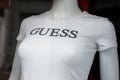 White tee-shirt for women by Guess on mannequin in a fashion store showroom