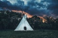 white teepee indian tent standing in beautiful landscape. Royalty Free Stock Photo