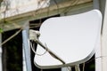 White telecommunication or television antenna in front of an old building in a sunny day