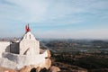 White temple on the big hill against the valley with river, sky and mountains in india hampi village Royalty Free Stock Photo