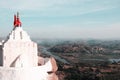 White temple on the big hill against the valley with river, sky and mountains in india hampi village Royalty Free Stock Photo