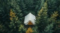 A white tent nestled in a lush green forest, seen from an aerial perspective. The tent is surrounded by tall trees, creating a