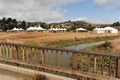 White tents in a dry field outdoors