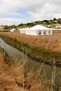 White tents in a dry field outdoors