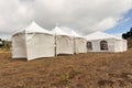 White tents in a dry field outdoors Royalty Free Stock Photo