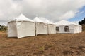 White tents in a dry field outdoors