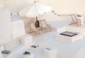 White terrace with deck chairs in caldera house, Santorini, Gree