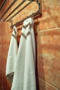 White terry towels hangs in the bathroom on the hanger. Royalty Free Stock Photo