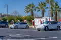 Tesla cars being charged at a Tesla charging station in Sacramento on a sunny day