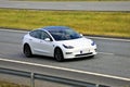 White Tesla Model 3 Electric Car on Motorway Royalty Free Stock Photo