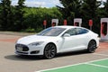 White Tesla Model S Electric Car Leaves Charging Station Royalty Free Stock Photo