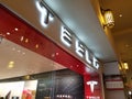 White Tesla sign with grey text above Store