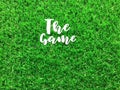 White text `The Game` on green football filed.