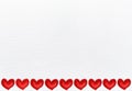 White textile background with a border of red valentine hearts Royalty Free Stock Photo