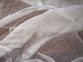 White texture of medical gauze lying wavy on a brown surface Royalty Free Stock Photo