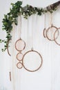 White textured bedroom in the style of shabby. Bed in an ecological style and Loft style. Rustic dream catchers on a white wall. Royalty Free Stock Photo