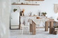 White textured kitchen in the style of shabby. A large table in an ecological style and loft style. Rustic shelves, napkins, old r Royalty Free Stock Photo