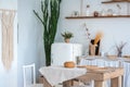 White textured kitchen in the style of shabby. A large textured table in the ecological style and Loft style. Rustic wicker napkin Royalty Free Stock Photo