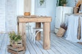 White textured kitchen in the style of shabby. A large textured table in the ecological style and Loft style. Rustic wicker napkin Royalty Free Stock Photo