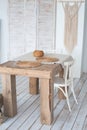 White textured kitchen in the style of shabby. A large table in an ecological style and loft style. Rustic shelves, napkins, old r Royalty Free Stock Photo