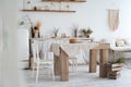 White textured kitchen in the style of shabby. A large table in an ecological style and loft style. Rustic shelves, napkins, old r Royalty Free Stock Photo