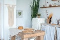 White textured kitchen in the style of shabby. A large textured table in the ecological style and Loft style. Rustic wicker napkin Royalty Free Stock Photo