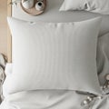 A white textured rectangular pillow placed on a neatly made bed with white bedsheets. A small Royalty Free Stock Photo