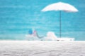 white textured surface on blur beach umbrella on the sea background Royalty Free Stock Photo