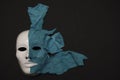 White theater mask on a black background covered with leather flaps. Psychic symbol of overlapping layers Royalty Free Stock Photo