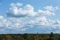 White and thick clouds in a blue sky. Cloudy sky and horizon