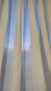 white thick curtains in the room in the evening, the sunset shines through